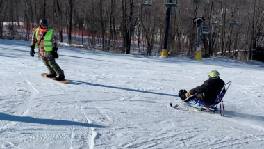 Adaptive skier at Cascade Mountain with snowboarder